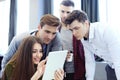 Group of buisness people working on tablet. Royalty Free Stock Photo