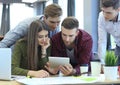 Group of buisness people working on tablet. Royalty Free Stock Photo