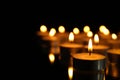 Group of burning candles on black background Royalty Free Stock Photo