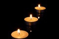 Group of burning candles on black background with reflection Royalty Free Stock Photo