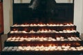 Group of burning candles on church altar close-up in christian catholic church, flaming candles, funeral, faith and memory concept