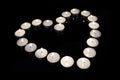 Group of burning candles forming a heart on black isolated background. Royalty Free Stock Photo