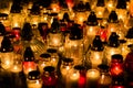 Group of burning grave candles during Polish All Saints` Day at cemetery. Royalty Free Stock Photo