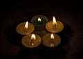 Group of burning small candles on a black background. Royalty Free Stock Photo