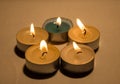 Group of burning small candles on a white background. Royalty Free Stock Photo