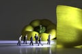 Group Of Business Figurines walk towards a lit and illuminated yellow pepper