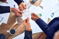 Group of business hands trying to connect puzzle pieces at office Royalty Free Stock Photo