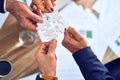 Group of business hands trying to connect puzzle pieces at office Royalty Free Stock Photo