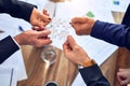 Group of business hands trying to connect puzzle pieces at office Royalty Free Stock Photo