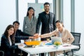 Group of business man and woman join hands together to show happy to work for success of the project in the office with day light Royalty Free Stock Photo