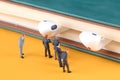 A group of business menÃ¢â¬â¢s miniature doll models are studying the headsets on the books