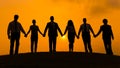 Group of business partner hold hand together in silhouette with sunrise background