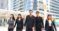 Group of business people asian team partners walking in city happy together. Leader executive men standing at modern urban city Royalty Free Stock Photo