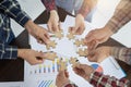 A group of business people assemble jigsaw puzzles, the concept of cooperation, Business teamwork concept, people join for the
