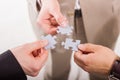 Group of business people assembling jigsaw puzzle. Teamwork. Royalty Free Stock Photo