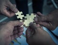 Group of business people assembling jigsaw puzzle wanting to put Royalty Free Stock Photo