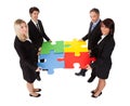 Group of business people assembling puzzle Royalty Free Stock Photo