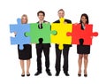 Group of business people assembling puzzle Royalty Free Stock Photo