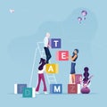 Group of business people carrying cubic box with word TEAM-Concept of teamwork