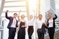 Group Of Business People Celebrating  of successful raised fist in the urban city on building background at workplace outdoors. Royalty Free Stock Photo