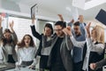 Group of business people celebrating by throwing their business papers and documents fly in air, Power of cooperation, Success