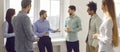 Group of business people chatting after a meeting. Company employees talking in the office.