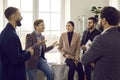 Group of business people chatting after a meeting. Company employees talking in the office.