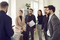 group of business people chatting after a meeting. company employees talking in the office