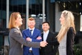 Businesswomen handshaking closing a deal with international investors. Royalty Free Stock Photo