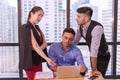 Group people colleagues talking about planning project in the workplace. Man holding pen with colleagues sitting on desk Royalty Free Stock Photo