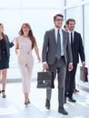 business people confidently walking in a modern office building Royalty Free Stock Photo
