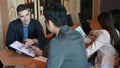 Group of business people  discussing financial documents together in meeting room. Royalty Free Stock Photo