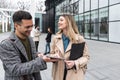 Group of business people discussing ideas at meeting outside. Businesswoman and businessman outdoor near office building talking Royalty Free Stock Photo