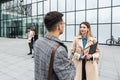 Group of business people discussing ideas at meeting outside. Businesswoman and businessman outdoor near office building talking Royalty Free Stock Photo