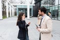 Group of business people discussing ideas at meeting outside. Businesswoman and businessman outdoor near office building talking Royalty Free Stock Photo