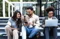 Group of business people discussing ideas at meeting outside. Businesswoman and businessman outdoor near office building talking Royalty Free Stock Photo