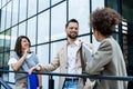 Group of business people discussing ideas at meeting outside. Businesswoman and businessman outdoor near office building talking Royalty Free Stock Photo