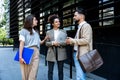 Group of business people discussing ideas at meeting outside. Businesswoman and businessman outdoor near office building talking Royalty Free Stock Photo