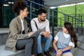 Group of business people discussing ideas at meeting outside. Businesswoman and businessman outdoor near office building talking Royalty Free Stock Photo