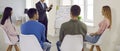 Group of business people discussing project and listening to speaker near whiteboard in office. Royalty Free Stock Photo