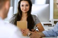 Group of business people discussing questions at meeting. Headshot of casual dressed businesswoman happy smiling to her Royalty Free Stock Photo