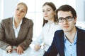 Group of business people discussing questions at meeting in modern office. Headshot of businessman at negotiation