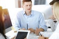 Group of business people discussing questions at meeting. Portrait of casual dressed businessman using smartphone at Royalty Free Stock Photo