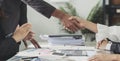 Group business people handshake at meeting table in office together. Young businessman and businesswoman workers express Royalty Free Stock Photo