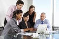 Group Of Business People Having Meeting Around Laptop At Glass T Royalty Free Stock Photo