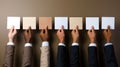 Group of business people holding blank paper cards on a wall background. Generative AI Royalty Free Stock Photo