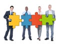 Group of Business People Holding Puzzle Pieces Royalty Free Stock Photo