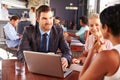 Group of business people with laptop meeting in coffee shop Royalty Free Stock Photo