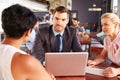 Group of business people with laptop meeting in coffee shop Royalty Free Stock Photo