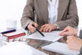 Group of business people and lawyers discussing contract papers sitting at the table, close up